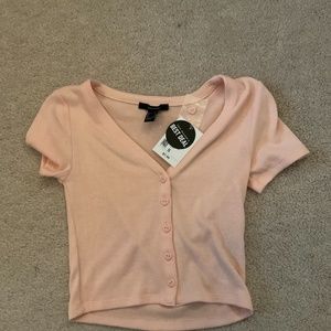 I am selling a adult women pink shirt with heart shaped buttons.